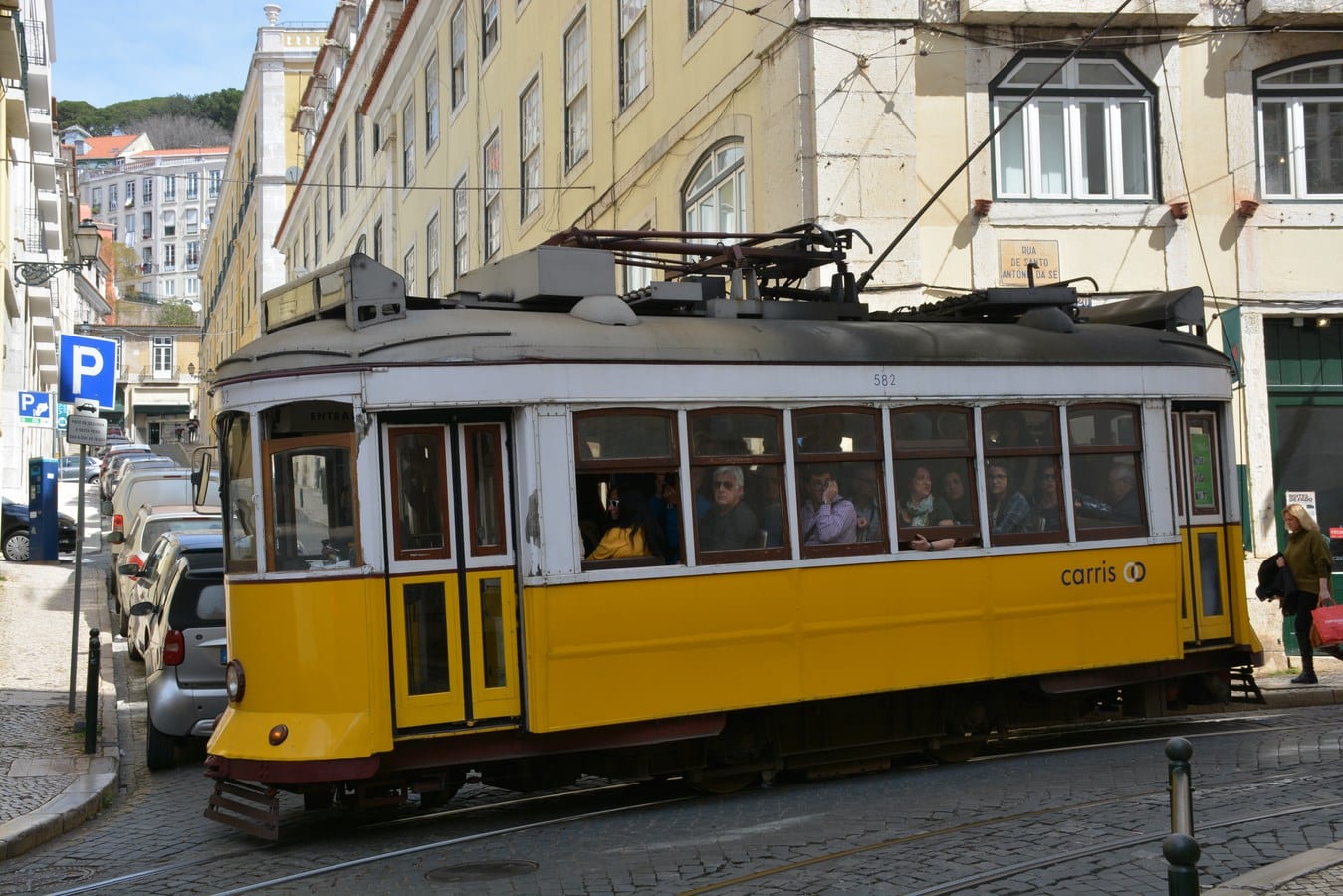 Yellow tram climbing colourful Lisbon streets — gateway to Portugal from cruise port